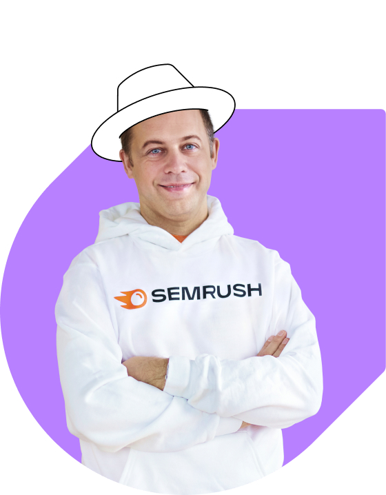 Photo of CEO and founder Oleg Shchegolev wearing a white hoodie with the Semrush logo and a white painted hat on his head